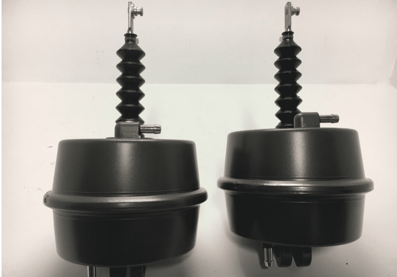 Two black and white photo of a car brake booster.